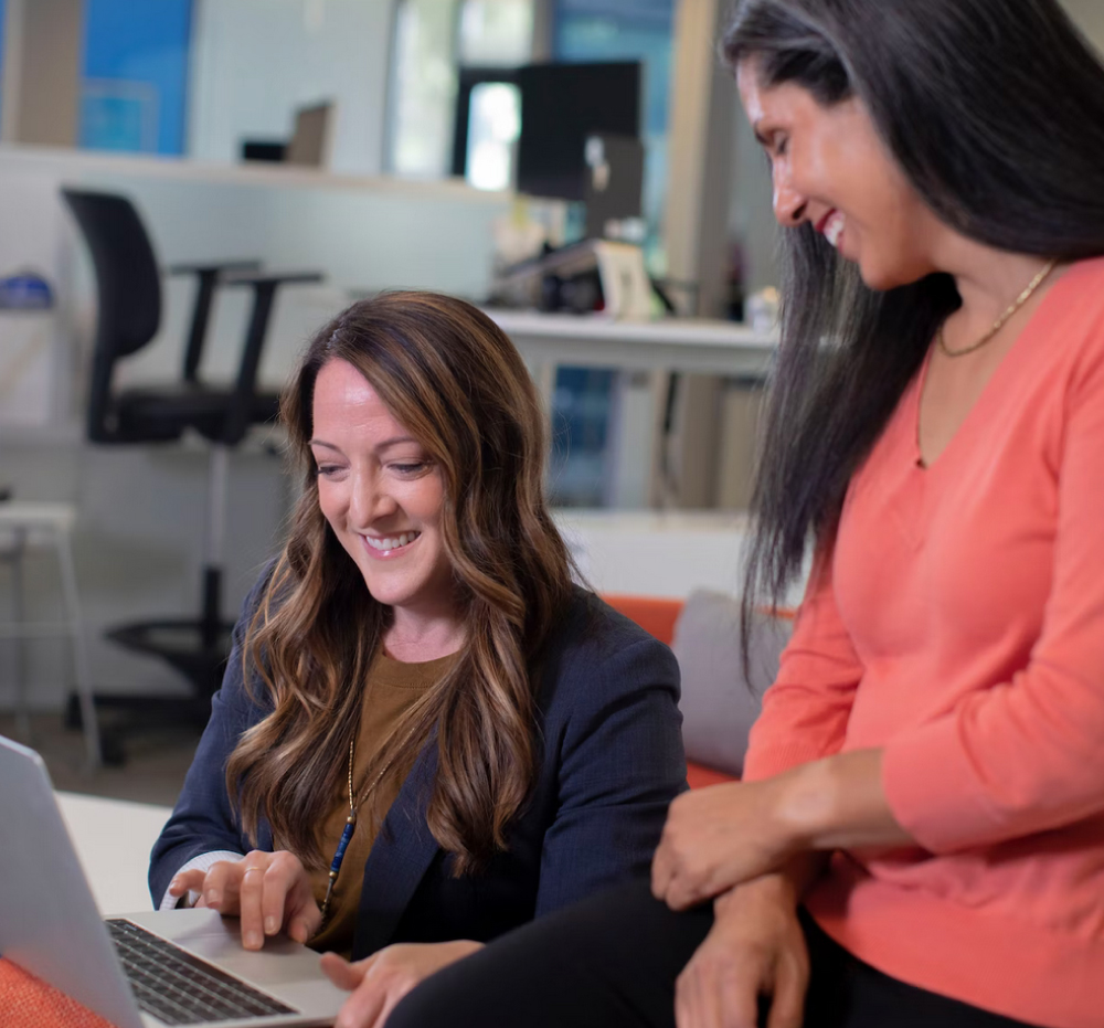 Two women using the software to build their CRM system