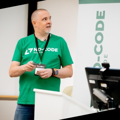 Adam Hill with a No Code T-shirt on giving a presentation