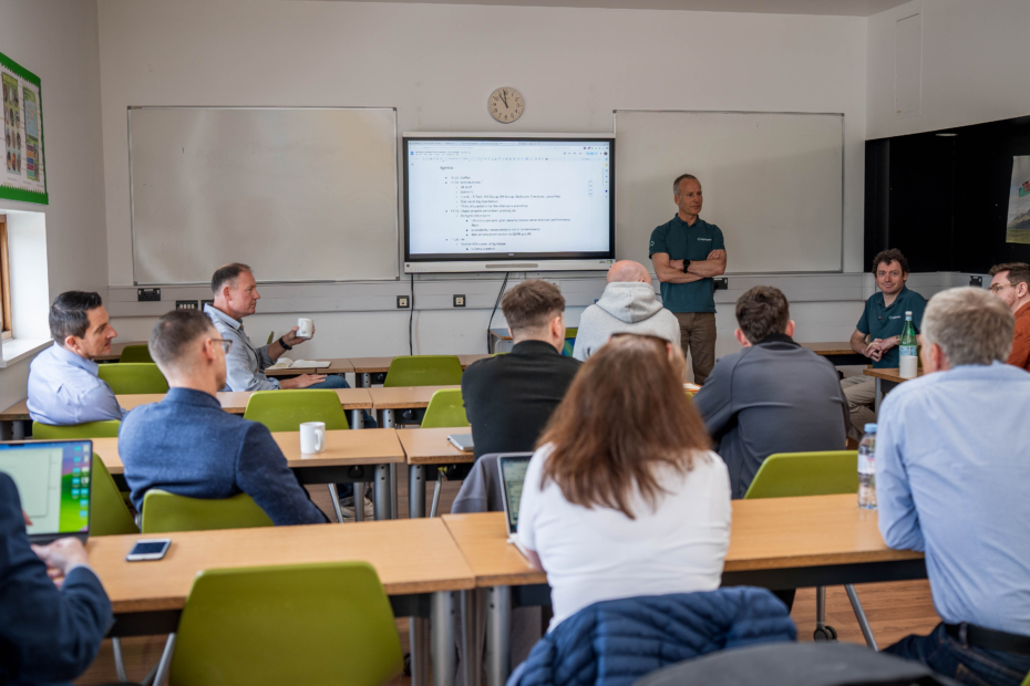 A dozen or so people in a classroom setting having a discussion